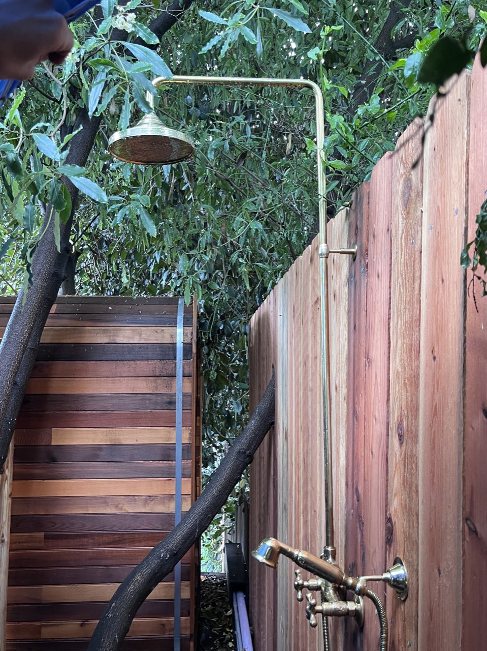 Brass outdoor shower, cedar wall