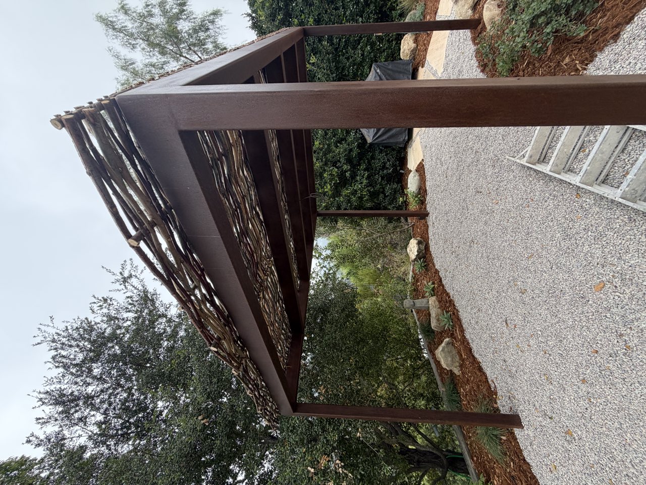 Corten steel pergola with woven roof