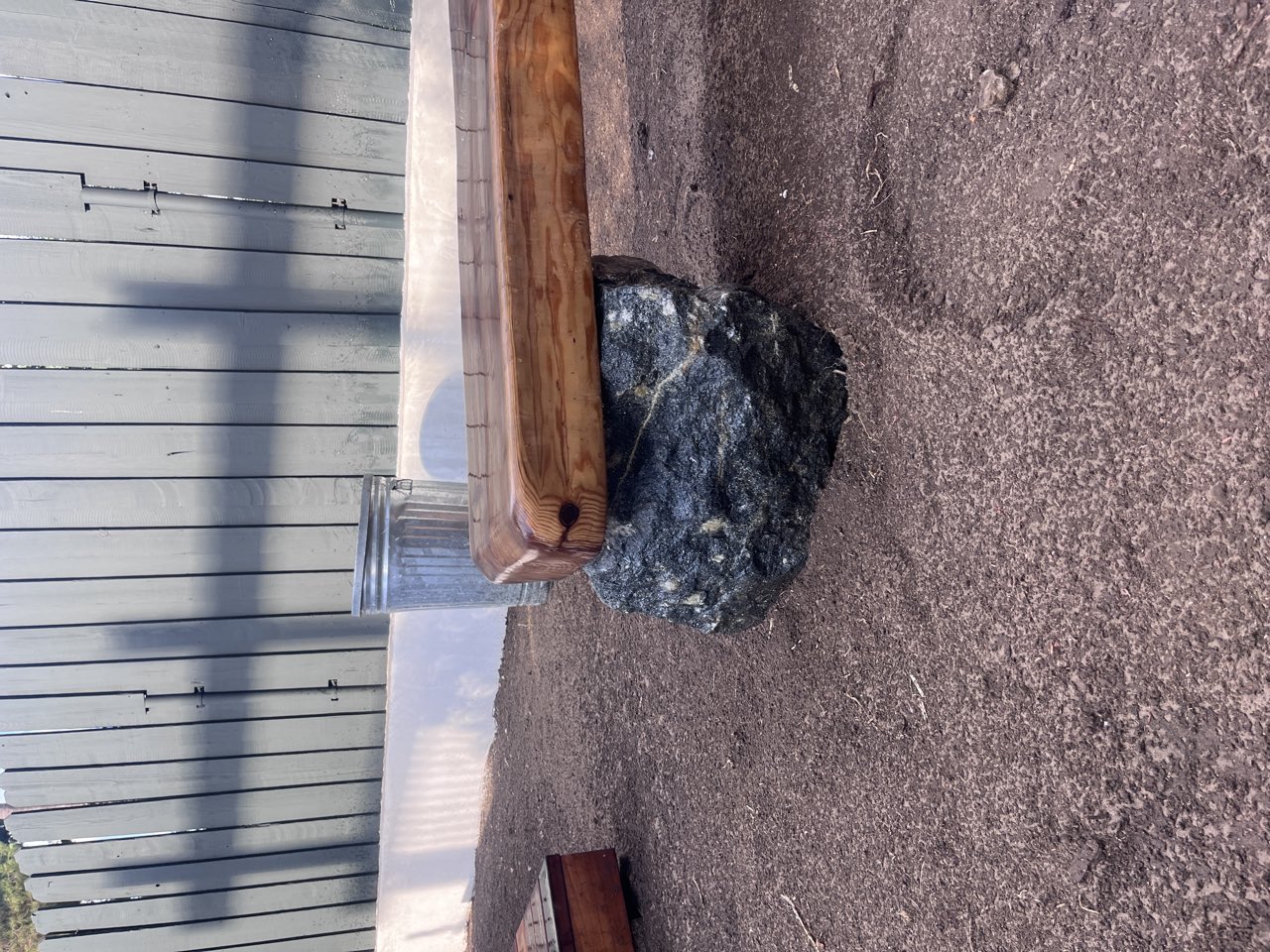 Live-edge wood bench on boulder
