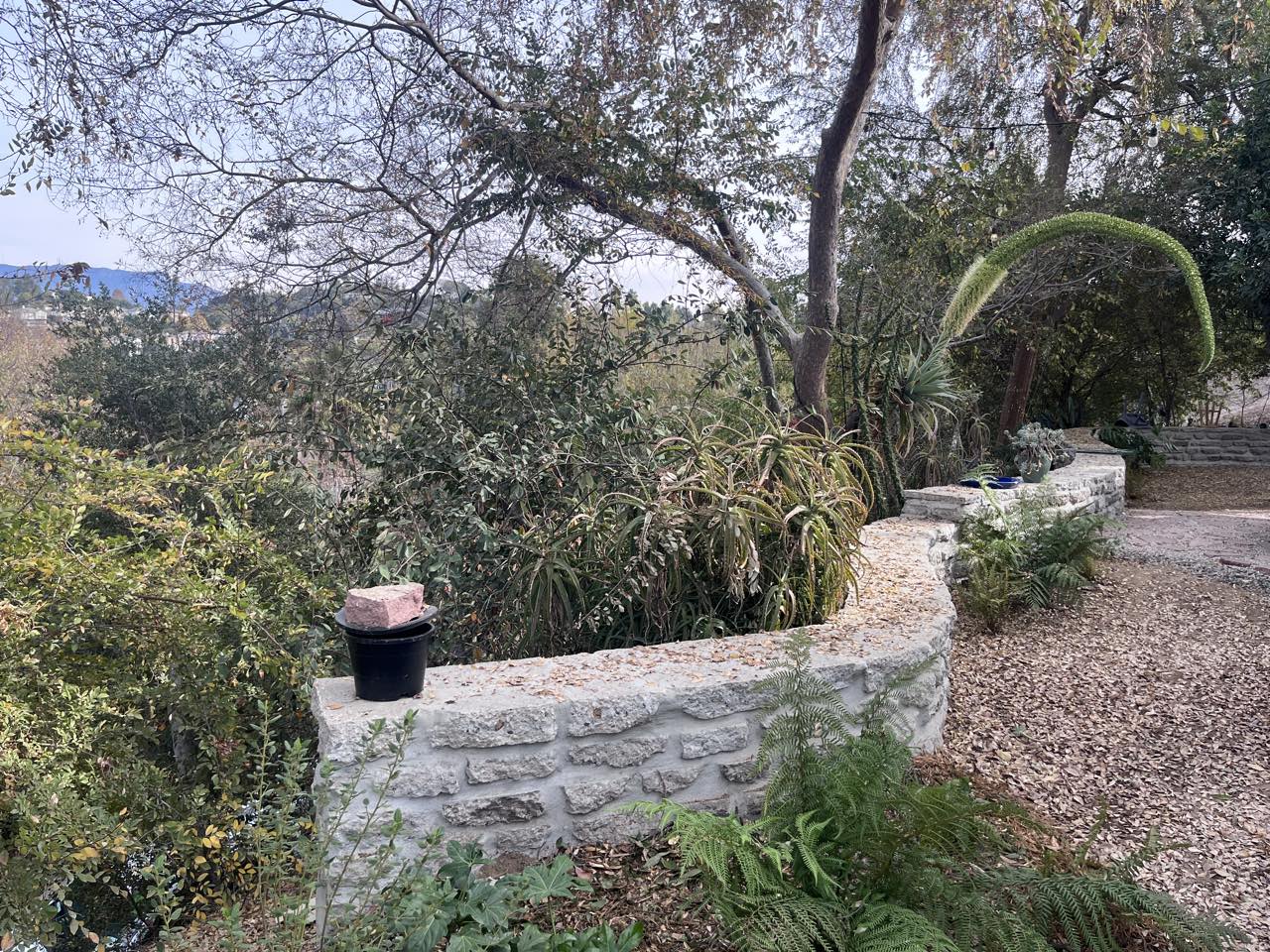 Stacked stone retaining wall & gravel path